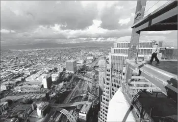  ??  ?? THE VIEW from the 64th f loor of the Wilshire Grand Center under constructi­on in downtown Los Angeles. The building, when f inished, will have a steel- and- glass crown with a spire and beacon reaching to 1,100 feet.