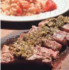  ?? GASSENHEIM­ER/TNS LINDA ?? Churrasco steak with chimichurr­i sauce and rice and tomatoes.