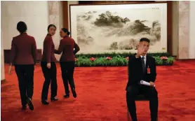  ?? Reuters; EPA ?? The image of founding father Mao Zedong, top, is present as the Communist Party of China meets for its 19th congress. In the Great Hall of the People, Beijing, stewards prepare for the five-yearly gathering