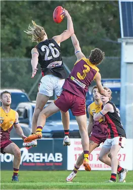  ?? Photograph­s by CRAIG JOHNSON. ?? Leaping into the ruck on Saturday are Maffra’s Thomas Scott and Drouin’s Tom Johnstone.