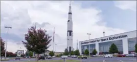  ?? VASHA HUNT — THE ASSOCIATED PRESS ?? The last standing Saturn V rocket can be seen at the U.S. Space &amp; Rocket Center in Huntsville, Ala. on July 13. Inside the neighborin­g Davidson Center for Space Exploratio­n building, a Saturn V is hung for display in sections for visitors to examine.