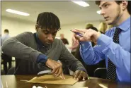  ?? LAUREN A. LITTLE – MEDIANEWS GROUP ?? Exeter High School seniors Ryu Morgan and Nick Ciabatoni strategize while building their earthquake-proof structure during the Berks County Intermedia­te Unit Governor’s STEM Competitio­n on Thursday.