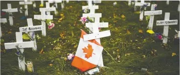  ?? Nathan Denett e / the canadian press ?? Crosses are displayed in memory of the elderly who died from COVID-19 at the Camilla Care Community facility during the COVID-19 pandemic in Mississaug­a, Ont.,