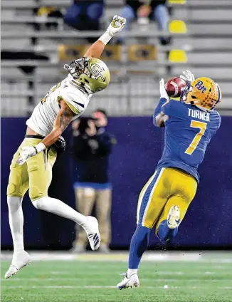  ?? HYOSUB SHIN/ HYOSUB. SHIN@ AJC. COM ?? Pittsburgh wide receiver DJ Turner catches a pass over Georgia Tech defensive back Tobias Oliver and runs for a touchdown in Thursday’s fifirst half at Bobby Dodd Stadium. The Jackets were a home underdog Thursday night; they’ll be a road underdog at Miami on Dec. 19.