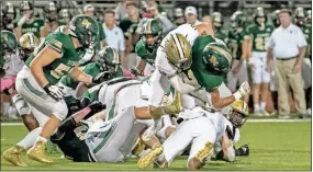  ?? Tim Godbee ?? Calhoun defensive end Lex Walraven skies to make a tackle Friday night against Blessed Trinity.