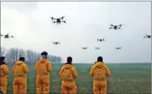  ?? LI SHIJU / FOR CHINA DAILY ?? A team of profession­al drone operators conducts a weeding operation in a wheat field in Dali county, Shaanxi province, on Feb 22.