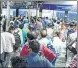  ??  ?? Commuters wait for tickets at Thane station