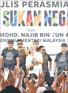  ??  ?? Najib uses a T-Shirt Gun at the launching of the 2017 National Sports Day at Bukit Jalil National Stadium in Kuala Lumpur. — Bernama photo