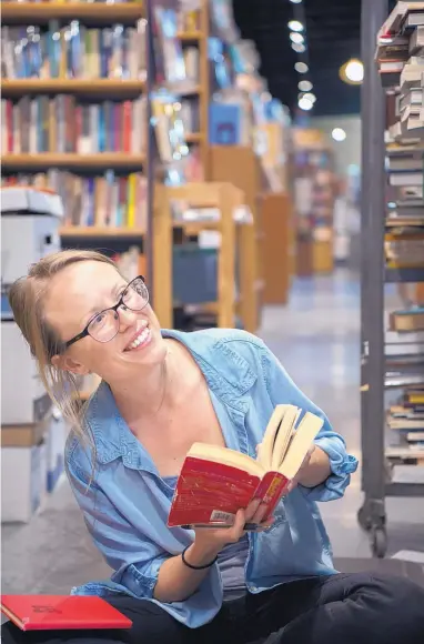  ?? EDDIE MOORE/JOURNAL ?? Alex Winter, an employeE at op.cit., sorts through donated books at the store in Santa Fe. Owner Noemi de Bodisco also has an outlet in Taos and another book store called Tome on the Range in Las Vegas, N.M.