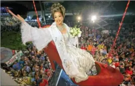  ??  ?? In this file photo, provided by the Florida Keys News Bureau, female impersonat­or Gary Marion, known as Sushi, hangs in a giant replica of a woman’s high heel shoe in Key West, Fla. The shoe with Sushi in it was lowered to Duval Street to mark the...