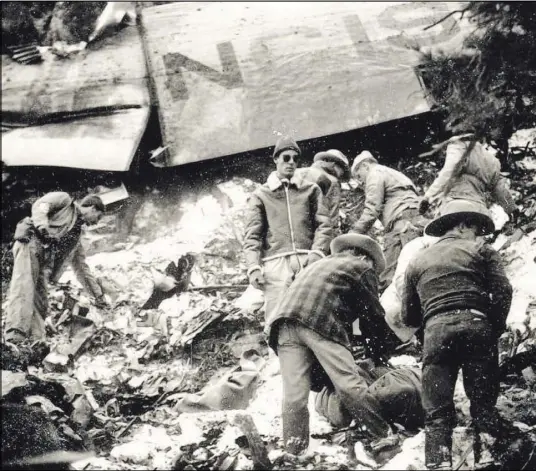  ?? COURTESY OF MIKE MCCOMB ?? A recovery team searches for remains at the site of a crash that killed actress Carole Lombard and 21 others on Jan. 16, 1942.