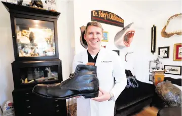  ?? JEFFEREE WOO Tampa Bay Times/TNS ?? Mike Foley owns a size 37AA shoe, the largest ever worn. It was made for the late Robert Wadlow, who at 8 feet, 11 inches is considered the world’s tallest man ever.