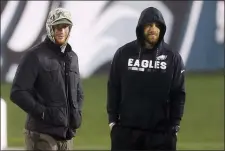  ?? RICH SCHULTZ — THE ASSOCIATED PRESS ?? Philadelph­ia Eagles’ Carson Wentz and Zach Ertz stand on the field hours after the Eagles lost to the Washington Football Team 20-14 in an NFL football game, Sunday, Jan. 3, 2021, in Philadelph­ia.