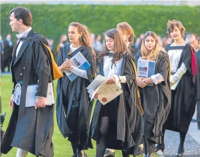  ??  ?? Students make their way to St Salvator’s quad, while, right, Honorary Graduand Professor Roger W. Smith is flanked by Sir Menzies Campbell and Principal Sally Mapstone.