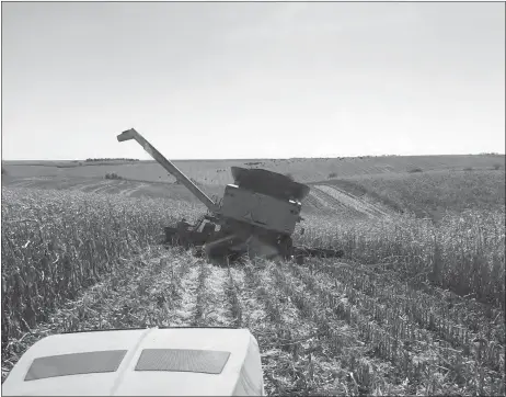  ?? Tim Lewandowsk­i ?? Harvest delays occurred in 2019 as additional heavy rains caused ditches from flooding. Shown above is a combine that fell in such a washout during harvest in Custer County.