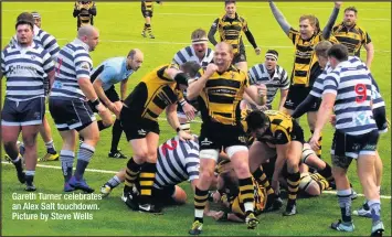  ??  ?? Gareth Turner celebrates an Alex Salt touchdown. Picture by Steve Wells