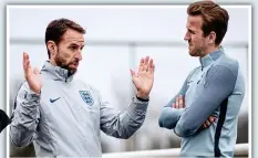  ?? ?? HArry KANE returned to England training yesterday . . . but spoke to Gareth Southgate (left) about his recovery from injury rather than taking any part in the session. The striker no longer needs a protective boot on his injured foot and is targeting Tottenham’s game against Brighton on April 17 to return. If that is the case, Kane will have up to six games at the end of the season to regain his sharpness before flying to russia. Jamie Vardy and Jack Butland are set to start against Italy at Wembley tomorrow.