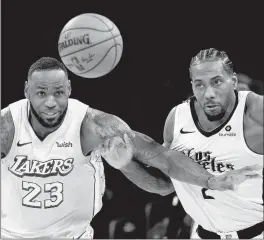  ?? RINGO H.W. CHIU/AP ?? Lakers' LeBron James (23) and Clippers' Kawhi Leonard will face off on Dec. 22.