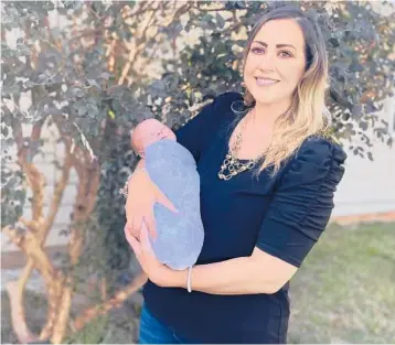  ?? KIM CHANDLER/AP ?? Amanda Harrison holds her baby, Lake, on Oct. 18 at her mother’s home in Phenix City, Alabama.