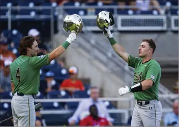  ?? JOHN PETERSON — THE ASSOCIATED PRESS ?? Notre Dame's Jared Miller (16) celebrates his home run against Texas with Carter Putz (4) during the first inning of an NCAA College World Series game Friday in Omaha, Neb.