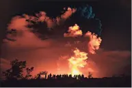  ?? Janice Wei / Associated Press ?? In this photo provided by the National Park Service, people watch an eruption from Hawaii's Kilauea volcano on the Big Island on Sunday. The volcano shot steam and an ash cloud into the atmosphere which lasted about an hour, an official with the National Weather Service said early Monday.