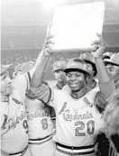  ?? AP FILE ?? Lou Brock celebrates with his Cardinals teammates after breaking Ty Cobb’s all-time stolen bases record during a game in 1977. Brock, like Aaron, died in the last year.