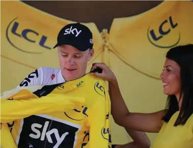  ?? AP ?? STILL THE MAN TO BEAT: Chris Froome puts on the overall leader’s yellow jersey on the podium of the fifteenth stage of the Tour de France in Le Puy-en-Velay yesterday.