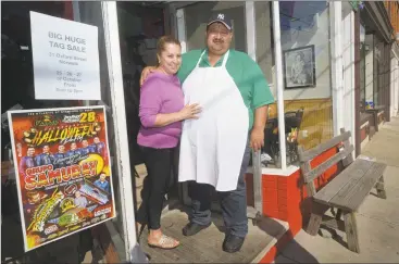  ?? Erik Trautmann / Hearst Connecticu­t Media ?? Owners of Los Molcajetes Mexican Restaurant Griselda Loza and her husband, Carlos Vargas, look out onto the newly reopened Liberty Square parking lot Wednesday.