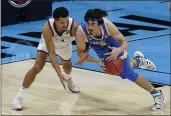  ?? DARRON CUMMINGS — THE ASSOCIATED PRESS ?? UCLA guard Jaime Jaquez Jr. (4) picks up a loose ball ahead of Gonzaga guard Jalen Suggs, left, during the first half of a men’s Final Four NCAA Tournament semifinal game Saturday at Lucas Oil Stadium in Indianapol­is.