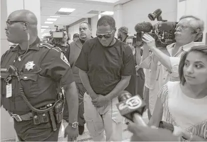  ?? Mark Mulligan / Houston Chronicle ?? Rapper Z-Ro, whose given name is Joseph Wayne McVey, leaves the Harris County Courthouse on Thursday after a judge agreed to a motion for emergency protection for his former girlfriend, who accuses him of assaulting her.