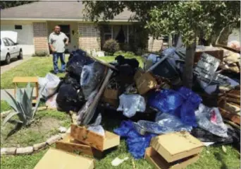  ?? FRANK BAJAK — THE ASSOCIATED PRESS ?? Salvador Cortez, 58, shows debris in the front yard of his home in Houston on Saturday. Unable to afford an alternativ­e and awaiting a solution from the Federal Emergency Management, he is sleeping in his musty, flood-gutted home.