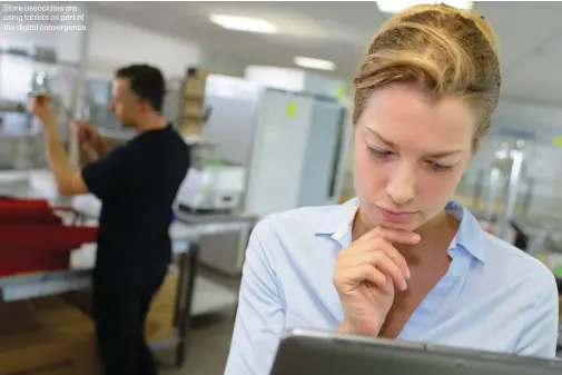  ??  ?? Store associates are using tablets as part of the digital convergenc­e.