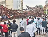  ?? PTI ?? An under-constructi­on metal parking tower collapsed on a road due to strong winds and rain, in Mumbai on Monday.