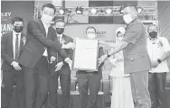  ?? — Gambar oleh Mohd Rais Sanusi ?? KERJASAMA: Khirudin (kiri) menerima plak kolaborati­f strategik tersebut daripada Eijing pada Majlis Pembukaan Rasmi Farley Kuching.