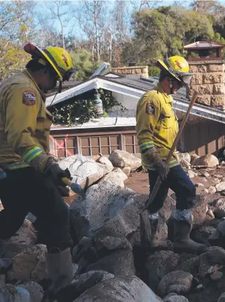  ?? AFTERMATH: Rescuers search for people trapped in mudslide debris in Montecito, California, after a tragedy that killed at least 17 people. Picture: GETTY IMAGES ??