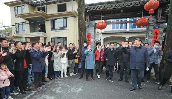 ?? JU PENG / XINHUA ?? President Xi Jinping greets villagers in Yucun in Zhejiang province’s Anji county on Monday during his inspection tour of the village, where he learned about local efforts to promote green developmen­t.