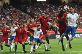  ?? AFP ?? Italian forward Simone Zaza ( right) jumps for the ball with Portuguese midfielder William Carvalho during their Nations League football match at the Luz Stadium in Lisbon on Monday. Portugal won 1- 0. —