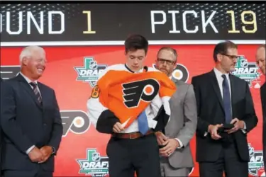  ?? MICHAEL AINSWORTH — THE ASSOCIATED PRESS ?? Jay O’Brien, second from left, puts on a Flyers jersey after being selected No. 19 overall in the first round by the Flyers Friday night in Dallas.