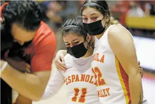  ??  ?? Española’s Anita Deaguero, left, gets a hug from Rhianna Padilla after their team lost the championsh­ip game 63-51 to Gallup.