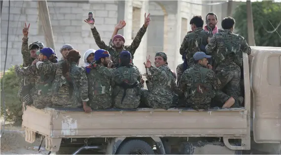  ?? Arab and Kurdish fighters with the US-backed Syrian Democratic Forces (SDF), move to the front line to battle Daesh militants in Raqqa in this July 22, 2017 file photo. ??