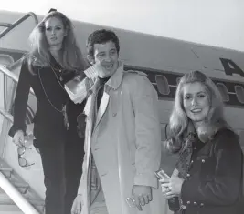  ?? AP, 1968 ?? Jean-Paul Belmondo is flanked by Ursula Andress, left, and Catherine Deneuve in Paris.