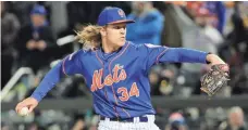  ?? ANTHONY GRUPPUSO, USA TODAY SPORTS ?? The Mets’ Noah Syndergaar­d got the win in Game 2 on Sunday, giving up one run and striking out nine in 5 2⁄3 innings.