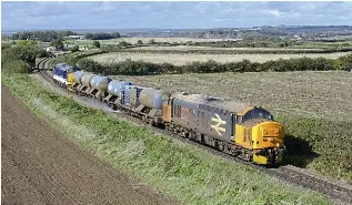  ?? ANDY MASON ?? The railhead treatment train (RHTT) season has been in full swing since the start of October, featuring traction from Classes 37, 56, 66, 69 and more. A sunny day in East Yorkshire on October 6, allowed this capture of Nos. 37407 Blackpool Tower and 37425 Sir Robert McAlpine/Concrete Bob at Gristhorpe (on the single line from Seamer to Filey) with the 3J51 York to York circular.