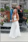  ??  ?? Graduate Lilly Pickett smiles with her diploma at the 204th commenceme­nt ceremony at Emma Willard School in Troy.