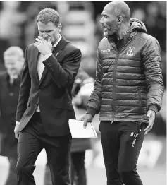  ??  ?? Crystal Palace manager Frank De Boer (left) walks off at half time during the English Premier League match against Burnley in Britain. — Reuters photo