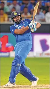  ??  ?? India’s captain Rohit Sharma plays a shot during the Asia Cup match against Pakistan at the Dubai Internatio­nal Cricket Stadium on Wednesday; (L) Off-spinner Kedar Jadhav celebrates a wicket