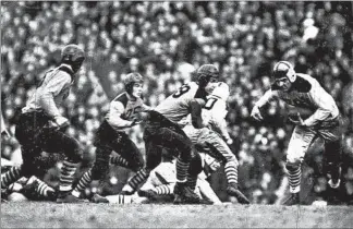  ?? AP ?? Halfback Bill DeCorrevon­t, of Public League champion Austin, carries the ball in the Prep Bowl on Nov. 27, 1937. Austin won the title 26-0 over Catholic League champ Leo before 120,000 spectators at Soldier Field.