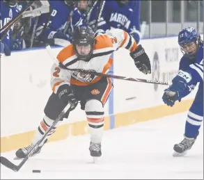  ?? H John Voorhees III / Hearst Connecticu­t Media ?? Ridgefield’s Nicky Cullinan (2) brings the puck across the blue line with Darien’s Jamison Moore (17) reaching out to hold him up in the boys ice hockey game between Darien and Ridgefield high schools on Friday night at Winter Garden Ice Arena in Ridgefield.