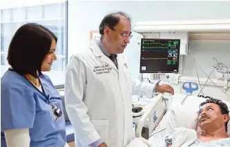  ??  ?? Dr. Alpesh Amin, a leader of the venous thromboemb­olism program at UC Irvine Medical Center, Orange, Calif., talks with a patient. The venous thromboemb­olism effort is one of the hospital’s DSRIP projects.