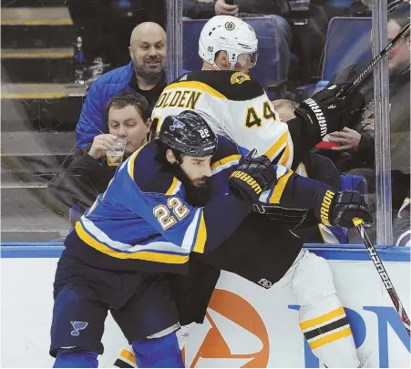  ?? AP PHOTO ?? BOARDED UP: St. Louis’ Chris Thorburn checks the Bruins’ Nick Holden into the boards during the B’s overtime loss to the Blues last night in St. Louis.